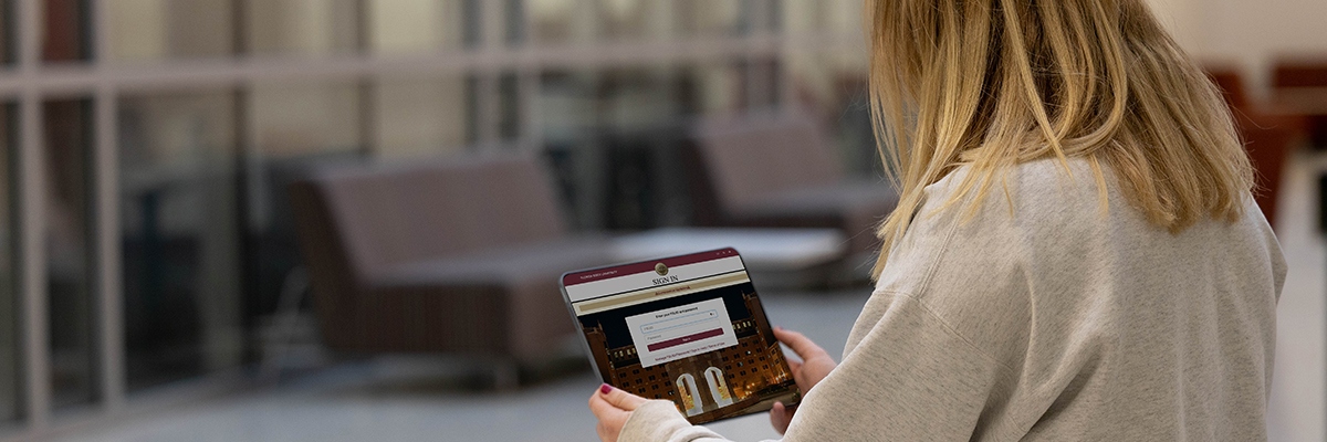 Image of person holding tablet with FSU email screen