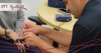 Yonatan Sarig hooks a student up to a biofeedback response system
