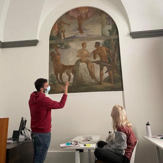 FSU Florence faculty member discusses original mural within the FSU Florence Palazzo Bagnesi with student