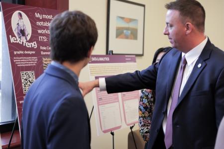 CIO Jonathan Fozard talks with student at 2024 ITS showcase event